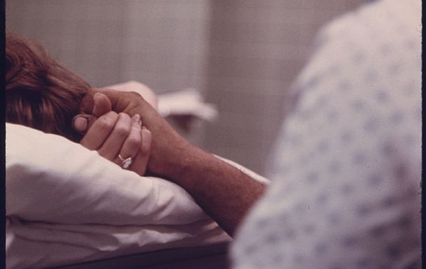 a husband holds his wife's hand during delivery of their baby in loretto hospital in new ulm minnesota